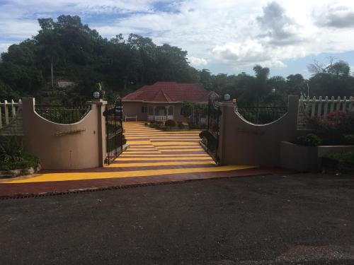 a gate leading to a house with a driveway at Cliffe Ranch in Mandeville