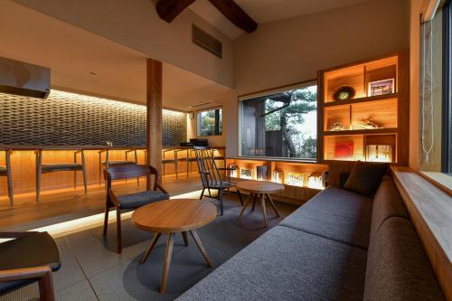 a living room with a couch and a table and chairs at 古淡 - Kotan in Awaji