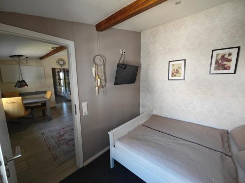 a bedroom with a bed and a living room at Ferienapartment MIA in Fritzlar