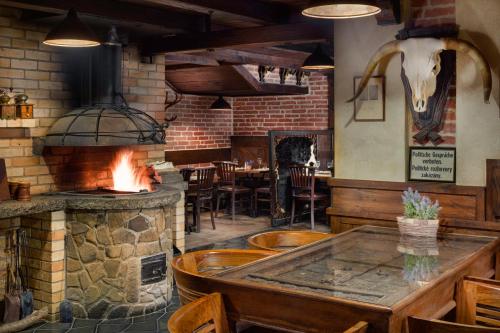 
a kitchen area with a stove, oven and a fire place at Hotel Oya in Prague
