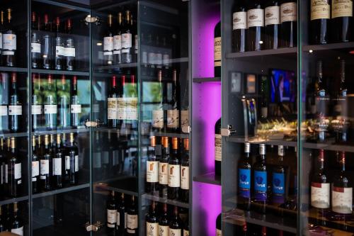 a display case filled with lots of bottles of wine at Hotel Loreak in Bayonne