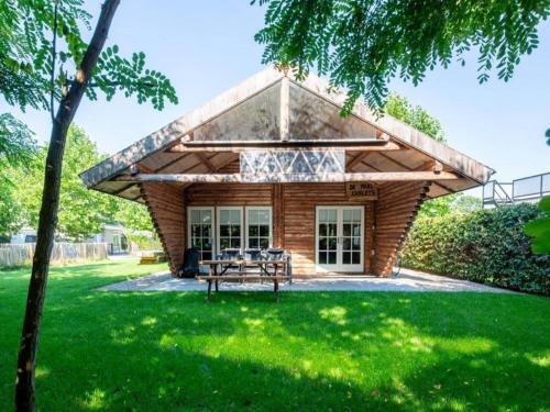 a pavilion with a picnic table in a yard at Thatched luxury leisure farm for 6 people in Baarle-Nassau