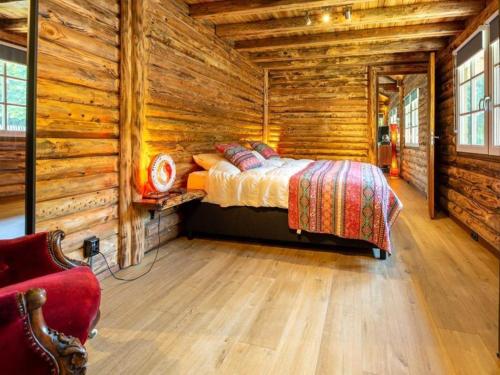 a bedroom with a bed in a log cabin at Thatched luxury leisure farm for 6 people in Baarle-Nassau