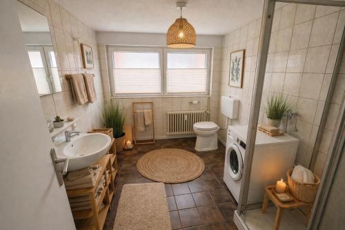 a bathroom with a sink and a washing machine at Bollenhut 1 in Bad Wildbad
