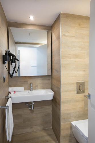 a bathroom with a sink and a mirror at Mar Hotels Playa Mar & Spa in Port de Pollensa