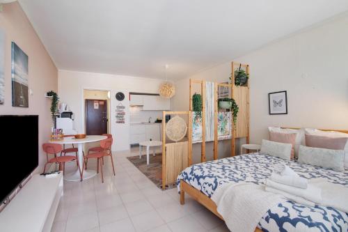 a bedroom with a bed and a dining room at Algarve Vilamoura Apartment in Quarteira