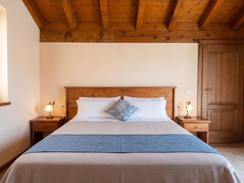 a bedroom with a large bed with two night stands at Garni Viggiona in Trarego