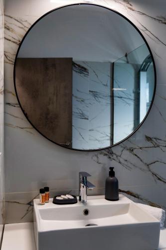 a bathroom sink with a large mirror on the wall at Kaliva Villa in Kerames
