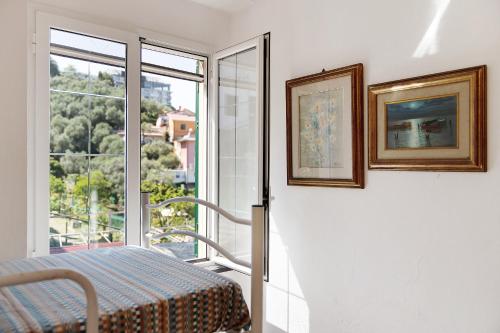 a room with a bed and two pictures on the wall at Ca' Da Giuvanna in Sestri Levante