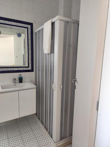 a bathroom with a shower and a sink and a mirror at Dimora Erminia in Polignano a Mare