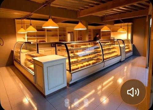 a bakery with a bunch of pastries on display at Duval in Calama