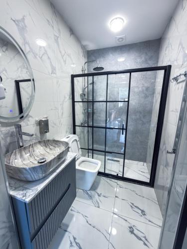 a bathroom with a sink and a toilet and a mirror at Forest Luxe A-Frame Villa in Quba