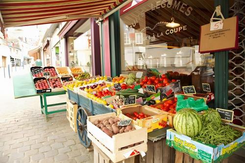 a produce market with fruits and vegetables on display at Grange Cottage - La Mare Chappey in Néhou