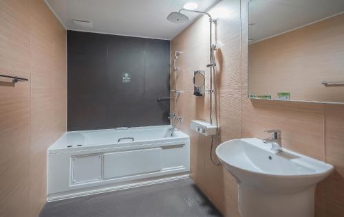 a bathroom with a sink and a shower and a toilet at Jeonju Wangyijimil Hanok Hotel in Jeonju
