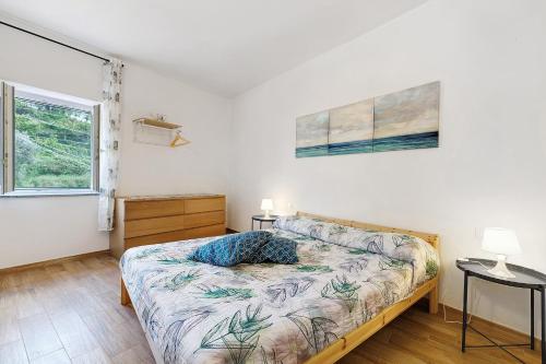a bedroom with a bed and a window at Casa Vacanze Il Primo Sole in Finale Ligure