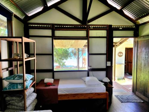 a bedroom with a bed in a room with a window at Matevulu Lodge in Amseran