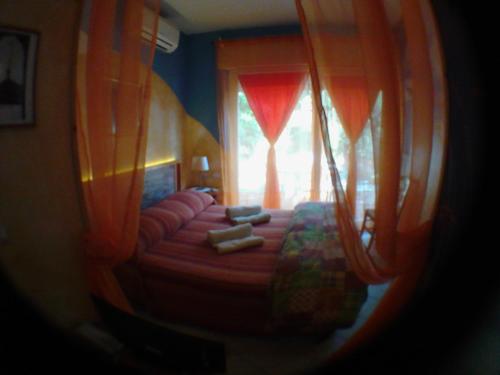 a view of a bedroom with a bed and a window at La Casa di Ulisse B&B in Quercianella