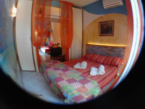 a bedroom with a bed and a red couch at La Casa di Ulisse B&B in Quercianella