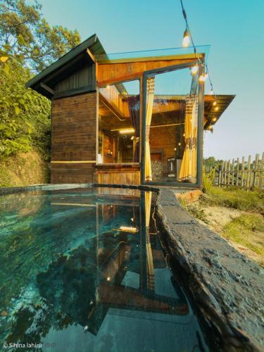 a house with a pool in front of it at Skyridge Infinity in Nuwara Eliya