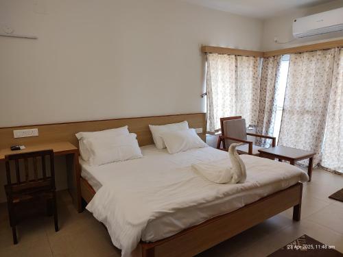 a bedroom with a large bed with a swan on it at KAIBALYA Bliss in Jāmb