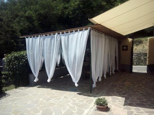 a row of white curtains on a patio at Borgo della Rocca in Montemurlo