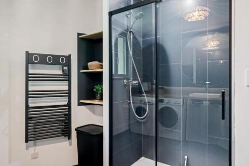 a shower with a glass door in a bathroom at Ferme du Bien Hêtre Gîte Sérénité in Saint-Arnoult