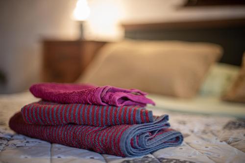 a pile of towels sitting on top of a bed at Andrea's Nido in Castel del Piano
