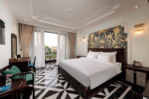 a hotel room with a bed and a balcony at SaLa Tam Coc Hotel & Spa in Ninh Binh