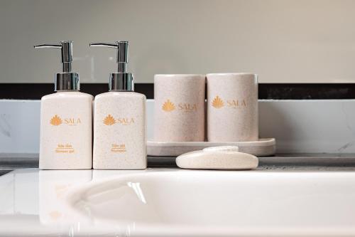 a group of four toilet paper rolls on a shelf at SaLa Tam Coc Hotel & Spa in Ninh Binh
