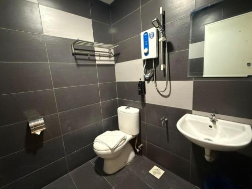 a bathroom with a toilet and a sink at Swing & Pillows - Skudai Johor in Skudai