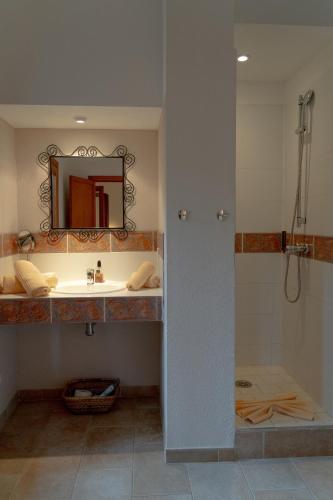 a bathroom with a sink and a mirror at Landhotel Can Davero in Binissalem