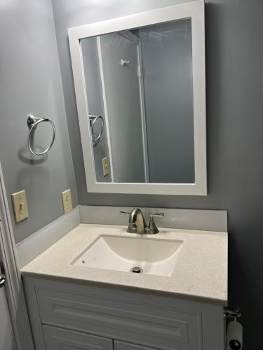 a bathroom with a sink and a mirror at Sweet Spot Stone Mountain in Stone Mountain
