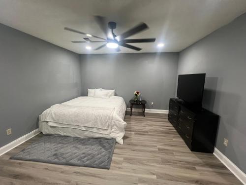 a bedroom with a bed and a ceiling fan at Sweet Spot Stone Mountain in Stone Mountain