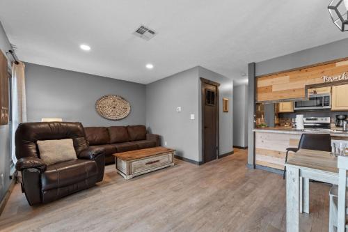 a living room with a couch and a table at Hole-in-One Hideaway For 4 in Branson