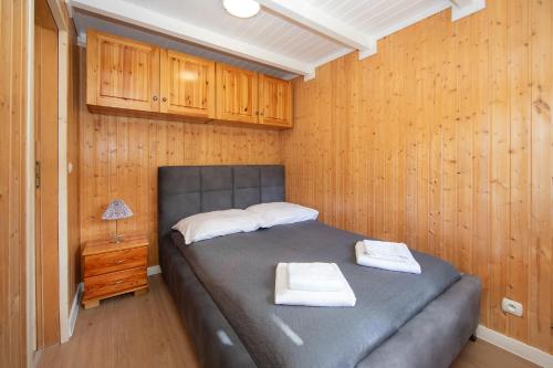 a bedroom with a bed with two towels on it at Domek na Górce in Lądek-Zdrój