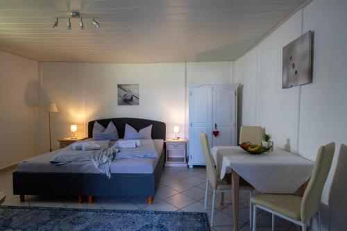 a bedroom with a bed and a table and chairs at Ferienpark Buntspecht in Pruchten