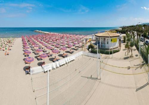 an overhead view of a beach with umbrellas and the ocean at KAI Apartment in Villa Rosa
