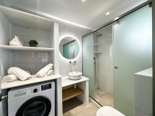 a washing machine in a bathroom with a shower at Vigla's Tiny House - Steps to the Beach in Mikri Vigla
