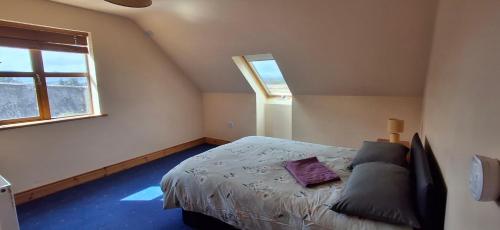 a bedroom with a bed and a window at Wooly Lodge in Westport