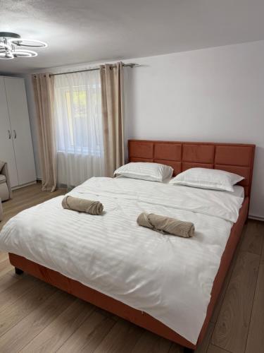 a bedroom with a large bed with two pillows on it at Casa TeoMar in Brad