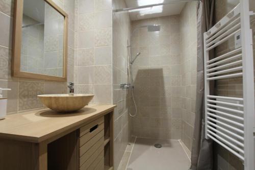 a bathroom with a bowl sink and a shower at Labourdette in Lasseube