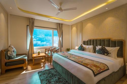 a hotel room with a bed and a window at Tripli Hotels Royal Spring in Mussoorie