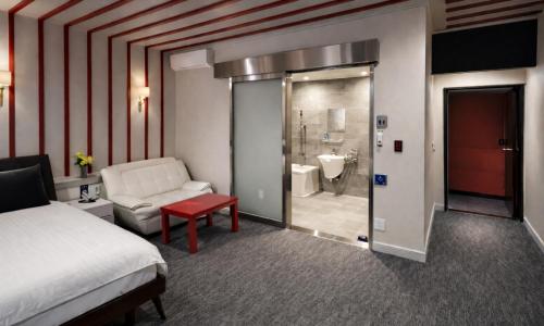 a hotel room with a bed and a bathroom at Sasang Goyohan-hotel in Busan