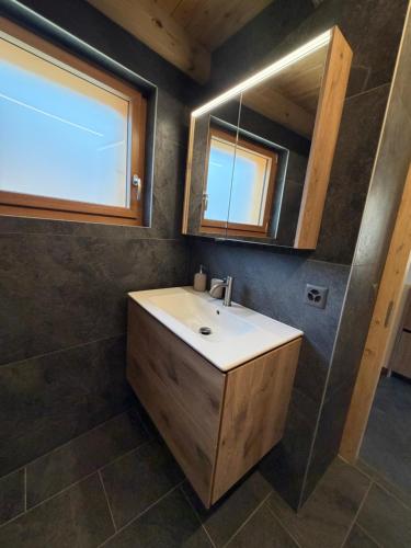 a bathroom with a sink and a mirror at Le mazot in Lens