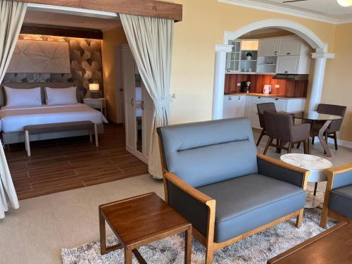 a living room with a bed and a dining room at Breakfast at Monaco - Palais Boracay in Boracay