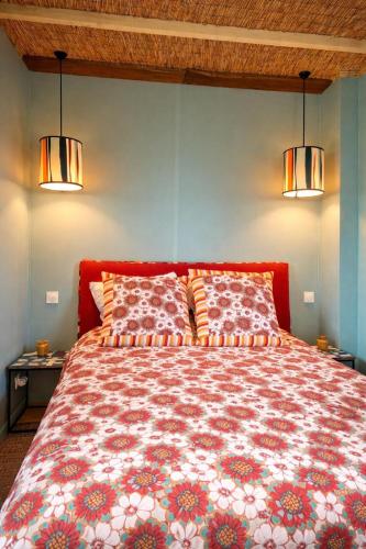 a bedroom with a large bed with two pillows at le clos d'Yrem in La Rochegiron