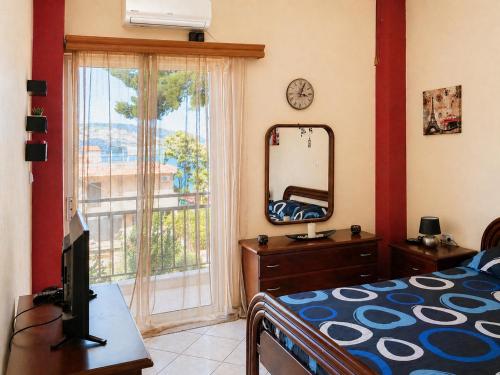 a bedroom with a bed and a mirror and a window at Vens apartment 90m2 at Eantio bay. in Aiándion