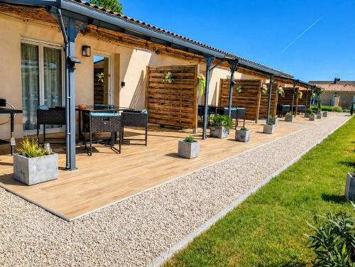 a patio with a table and chairs on it at Gite Les Intemporels in Cuisery