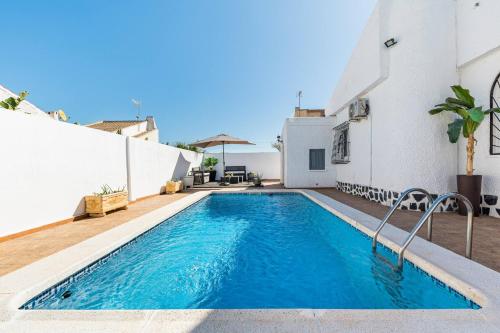 a swimming pool in the backyard of a house at Chalet Queen Venecia Sunrise in Campoamor