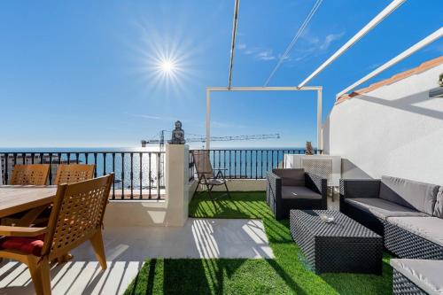 a balcony with a table and chairs and the ocean at Tabarca’s View Santa Pola in Santa Pola